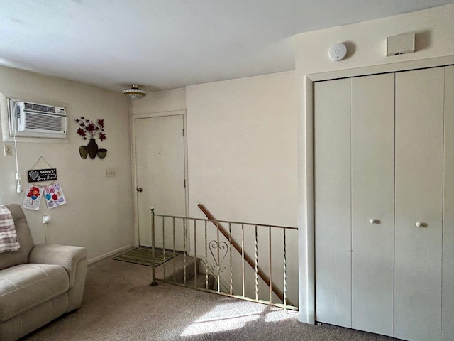 interior space with carpet floors and a wall mounted air conditioner