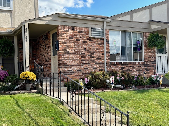 view of home's exterior featuring a yard, brick siding, and stucco siding