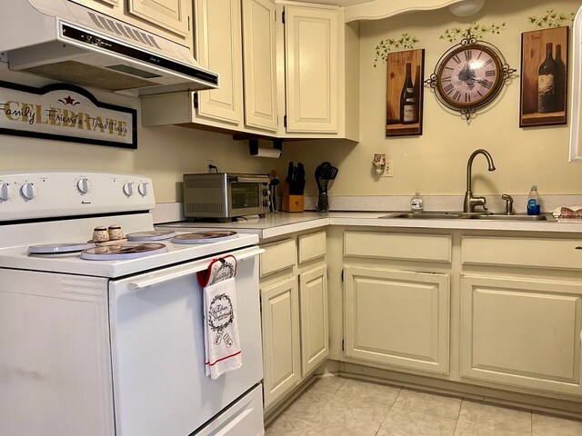 kitchen featuring white electric range and sink