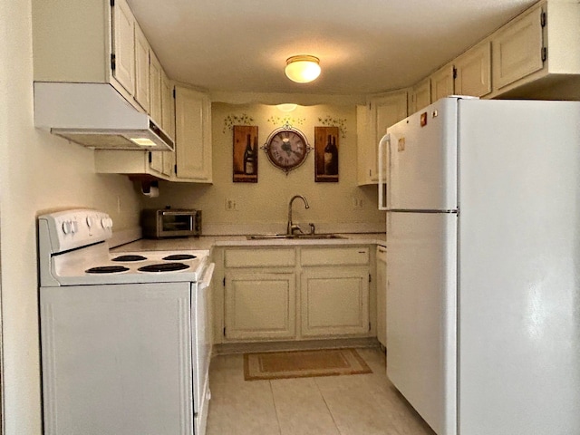 kitchen featuring light tile patterned floors, a toaster, white appliances, a sink, and light countertops