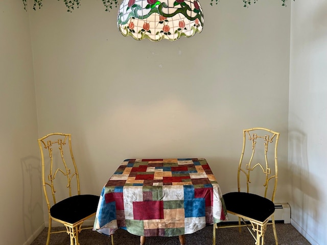 dining room with a baseboard radiator and baseboards