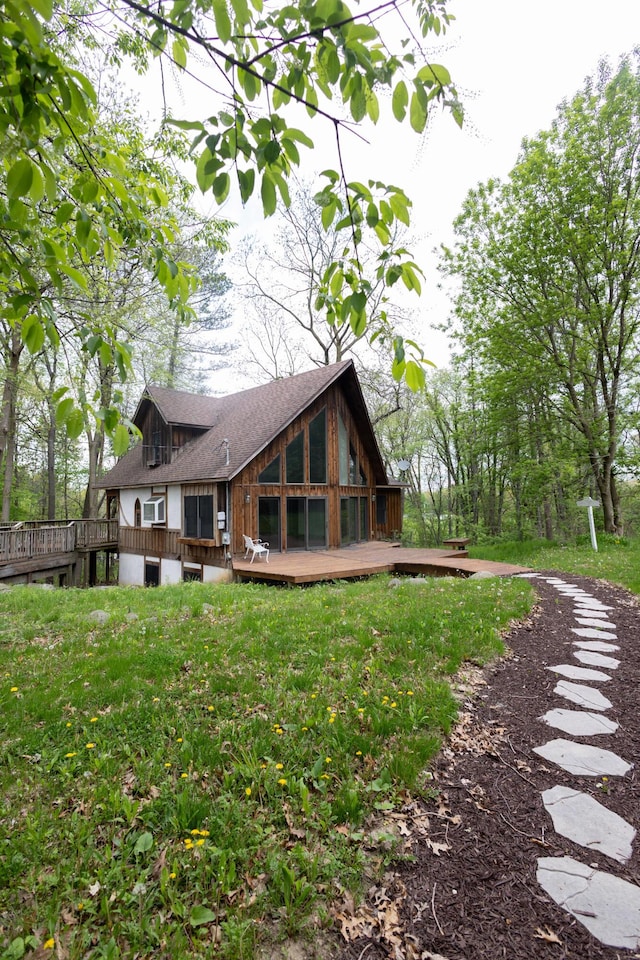 6020 Clark Rd, Bath, MI 48808 - back of house with a wooden deck, a lawn, and roof with shingles