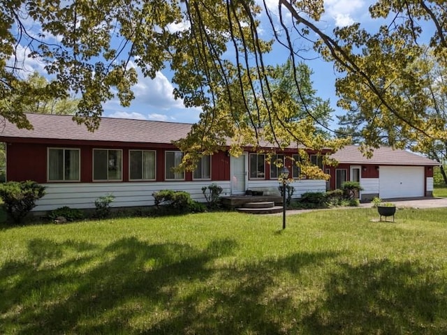 ranch-style house featuring a garage and a front yard