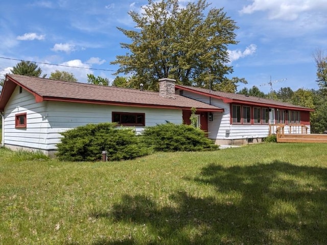 rear view of property with a yard