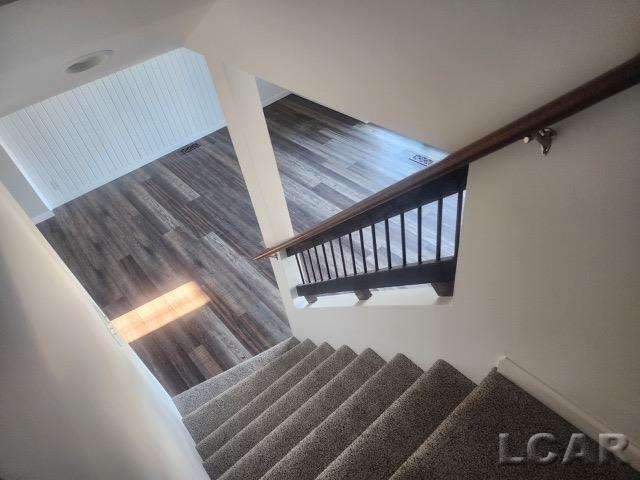 staircase with wood finished floors