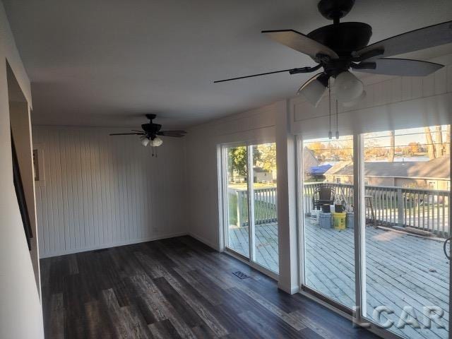 interior space featuring dark wood-style flooring and ceiling fan