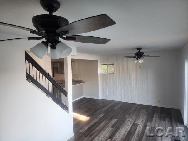 unfurnished room featuring dark wood-style floors and ceiling fan