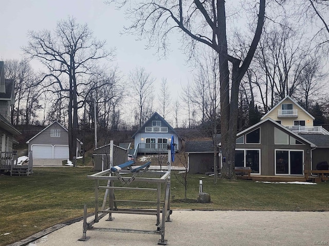 view of front of property with a wooden deck, a front lawn, and an outdoor structure