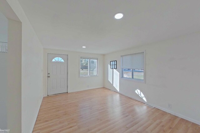 foyer entrance with light wood-type flooring