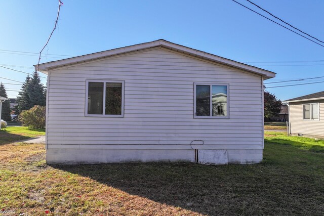 view of property exterior with a yard