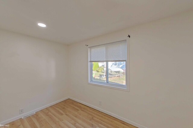 spare room featuring light wood-type flooring