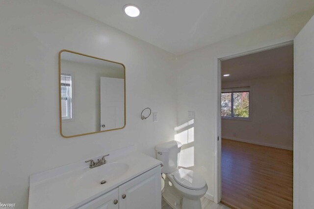 bathroom featuring hardwood / wood-style floors, vanity, and toilet