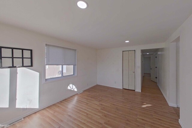 unfurnished room with light wood-type flooring