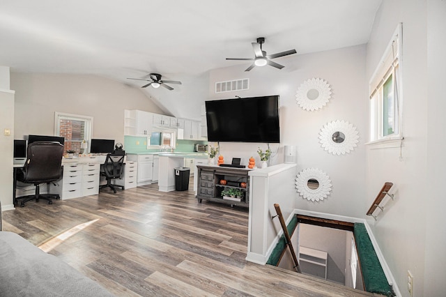 office featuring hardwood / wood-style flooring, ceiling fan, and vaulted ceiling