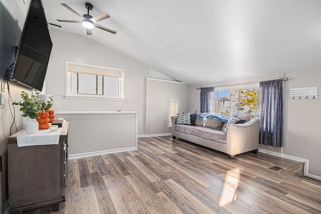 living room with ceiling fan, lofted ceiling, and hardwood / wood-style flooring