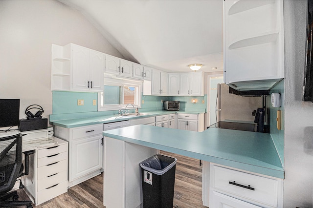 kitchen featuring dark hardwood / wood-style flooring, vaulted ceiling, sink, black range, and white cabinetry