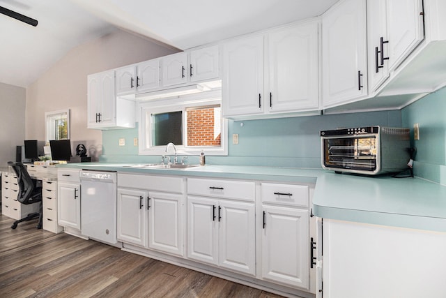 kitchen featuring sink, dishwasher, lofted ceiling, white cabinets, and hardwood / wood-style flooring