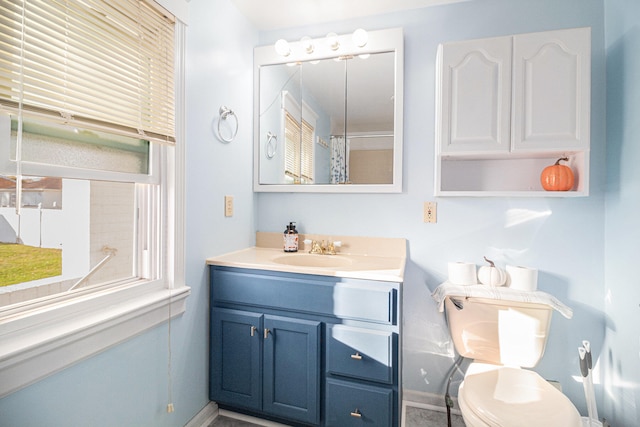 bathroom with a shower with curtain, vanity, toilet, and a wealth of natural light