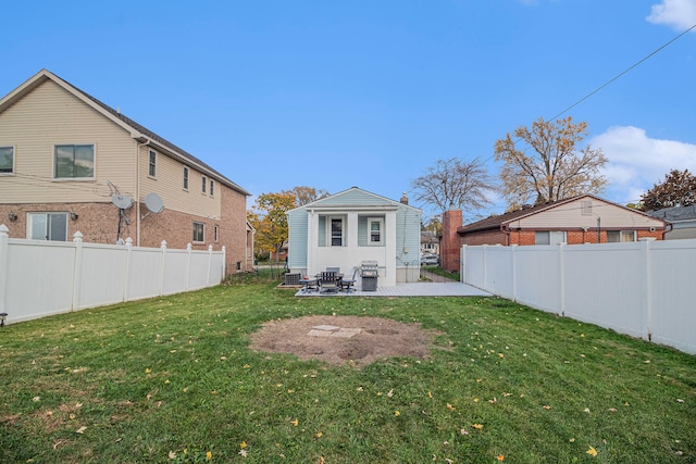 rear view of house featuring a lawn and a patio area