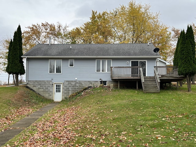 rear view of house with a yard and a deck