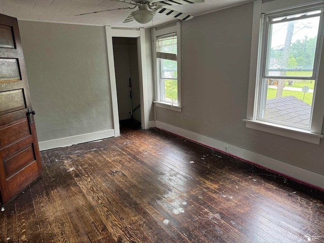 unfurnished bedroom featuring a closet, ceiling fan, and dark hardwood / wood-style flooring