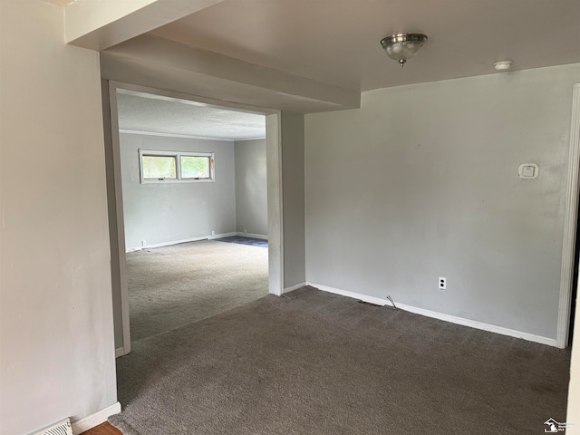 empty room with dark carpet