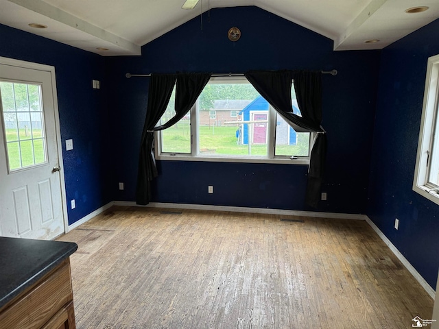 interior space featuring hardwood / wood-style floors and lofted ceiling