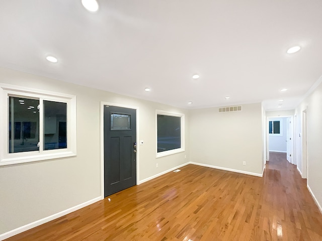 empty room with light hardwood / wood-style flooring