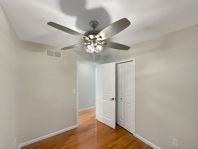 interior space featuring hardwood / wood-style flooring, ceiling fan, and a closet