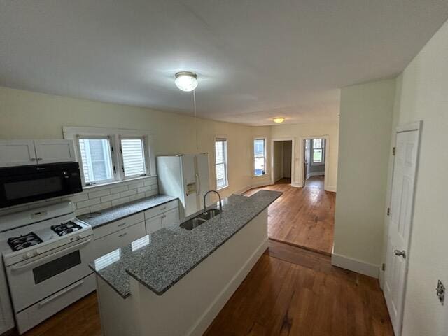 kitchen featuring white cabinetry, sink, dark wood-type flooring, light stone counters, and white appliances