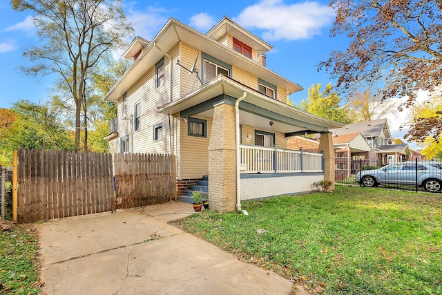 view of property exterior with covered porch and a lawn