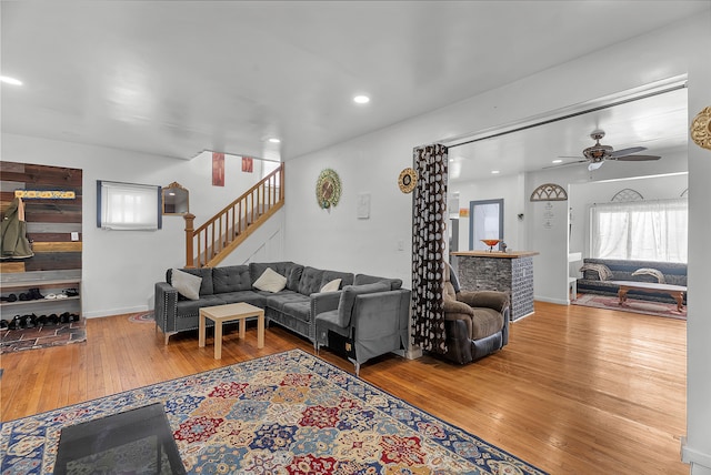 living room featuring hardwood / wood-style floors and ceiling fan