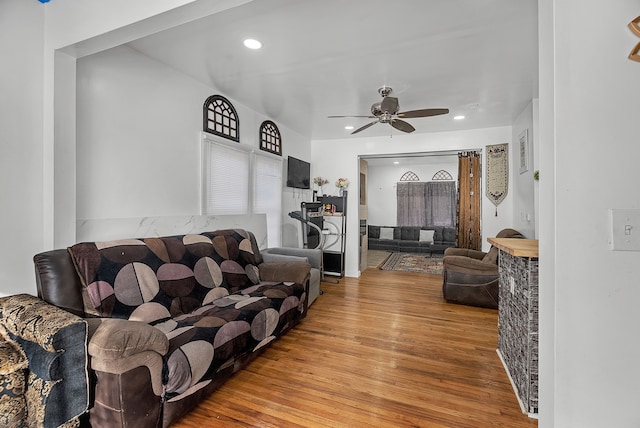 living room featuring hardwood / wood-style flooring and ceiling fan