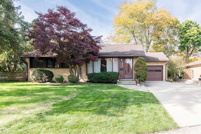 view of front of property with a garage and a front lawn