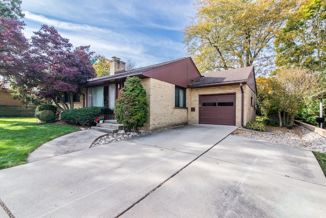 view of side of property with a garage and a yard