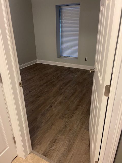 empty room featuring dark hardwood / wood-style flooring