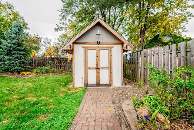 view of outbuilding with a lawn