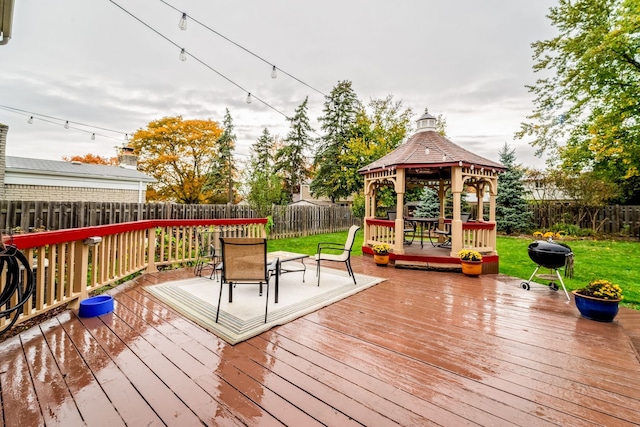 deck with a gazebo, area for grilling, and a lawn