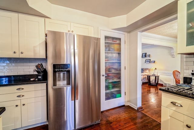 kitchen featuring stainless steel fridge with ice dispenser, dark hardwood / wood-style flooring, tasteful backsplash, and white cabinetry