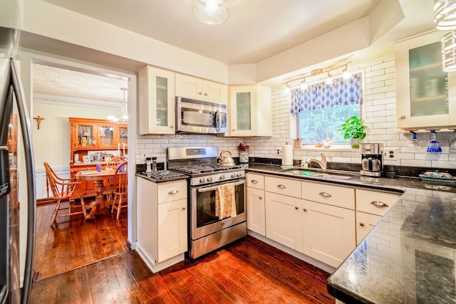 kitchen featuring appliances with stainless steel finishes, dark hardwood / wood-style flooring, white cabinetry, and sink