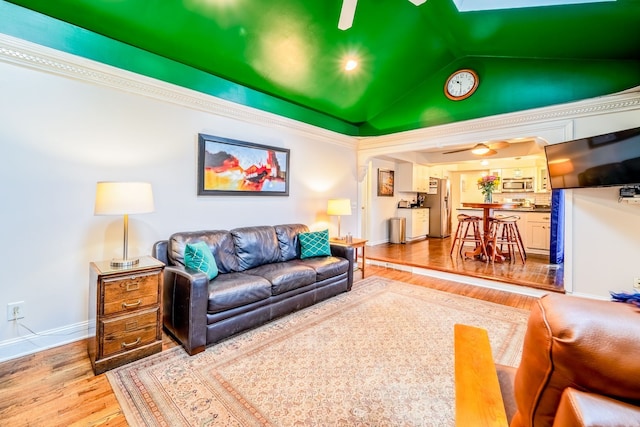 living room with hardwood / wood-style floors, ceiling fan, and lofted ceiling