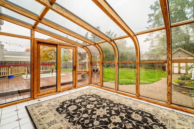 unfurnished sunroom featuring beamed ceiling