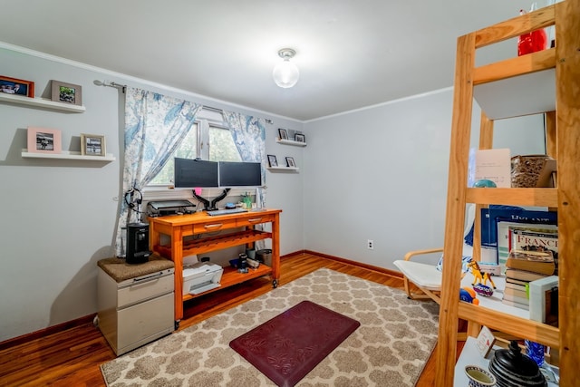 office area with hardwood / wood-style flooring and crown molding