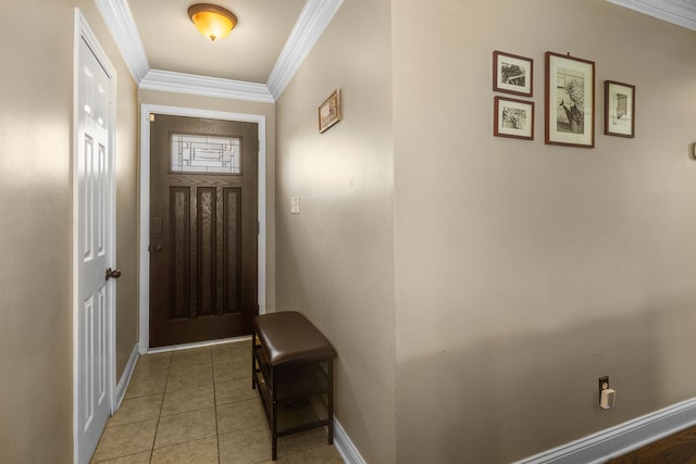 tiled entryway featuring crown molding