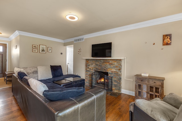 living room with dark wood-type flooring, a fireplace, and crown molding