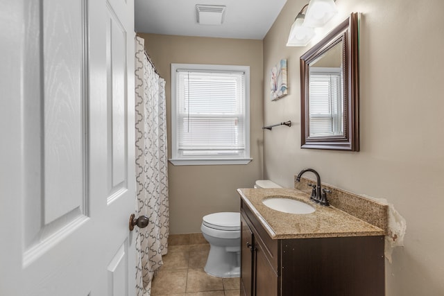 bathroom with vanity, tile patterned floors, and toilet