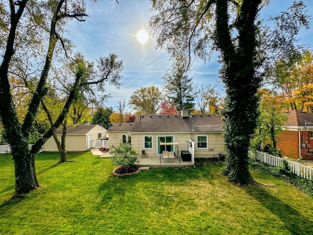 rear view of property with a yard and a patio