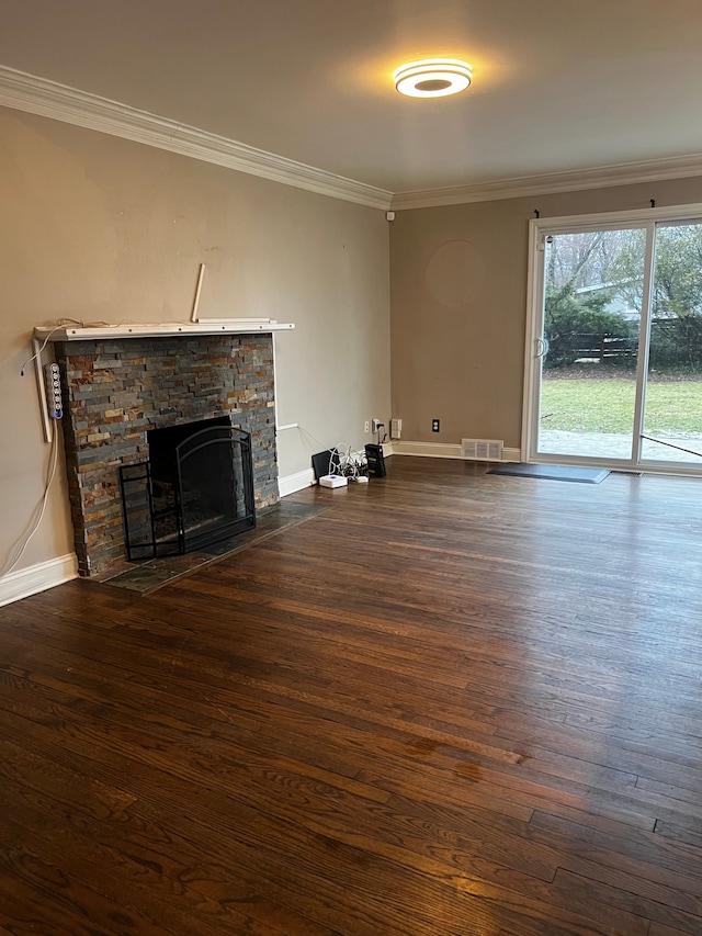 unfurnished living room with a stone fireplace, dark wood-type flooring, and ornamental molding