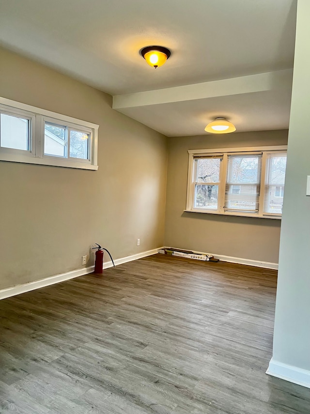 unfurnished room with hardwood / wood-style flooring