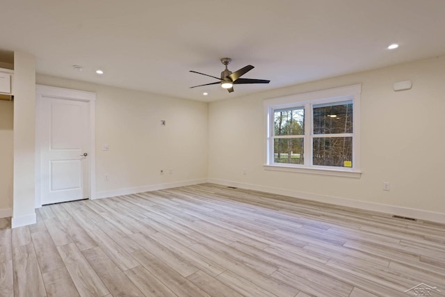 empty room featuring ceiling fan and light wood-type flooring